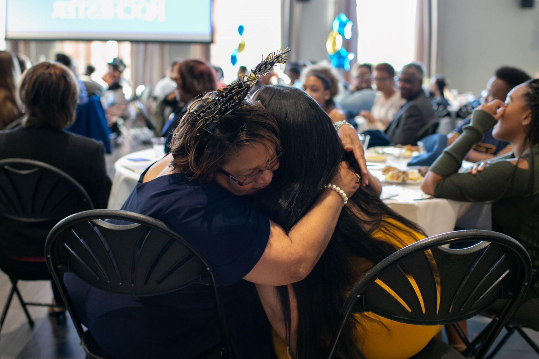 A mother hugs her daughter